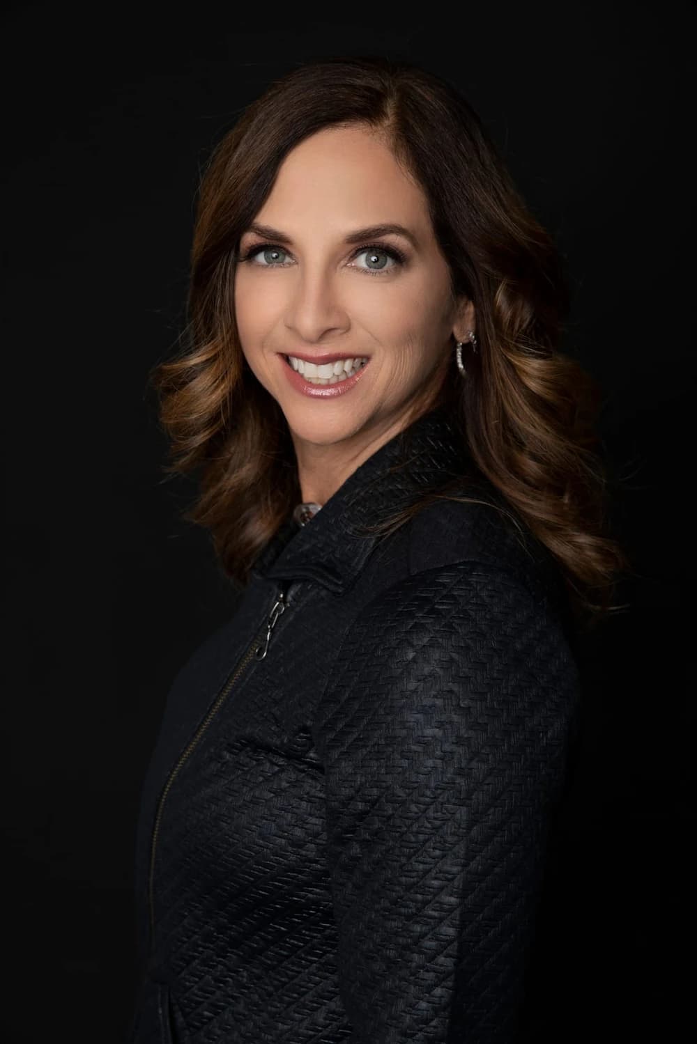 Julie Wright Halbert, photographed against a dark ground