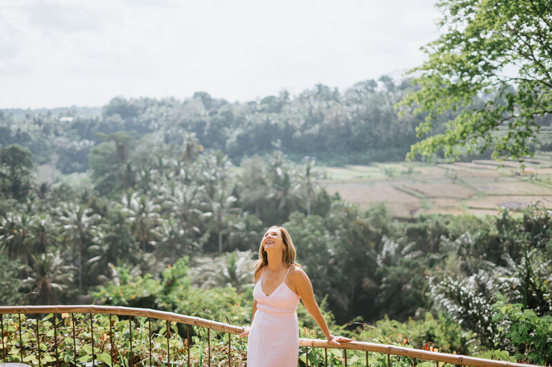 Julie Wright Halbert at a curved rail, looking up over a wide green valley